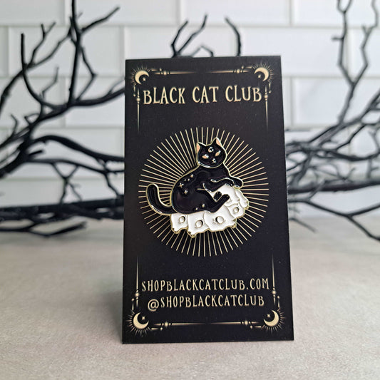 Black Cat on a Pile of Cat Skulls Enamel Pin
