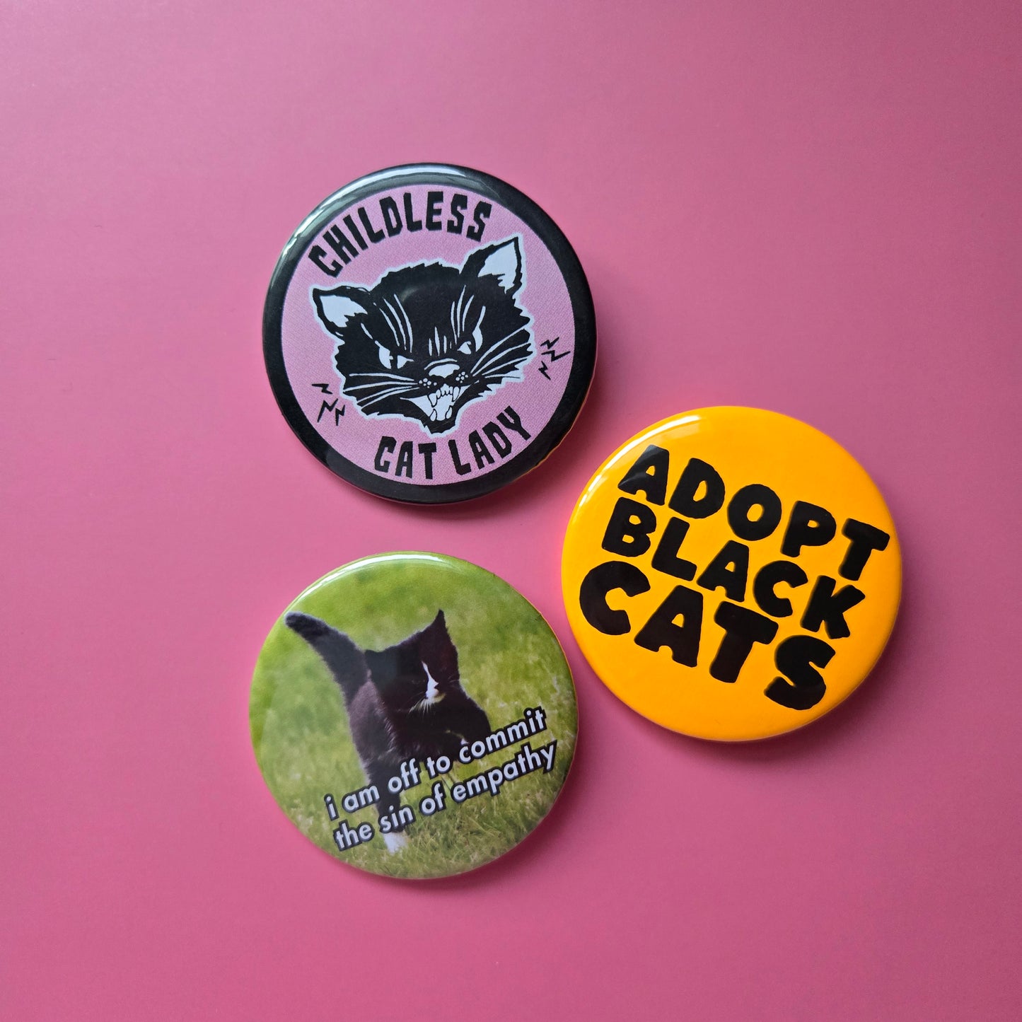 display of 3 round buttons on a pink background