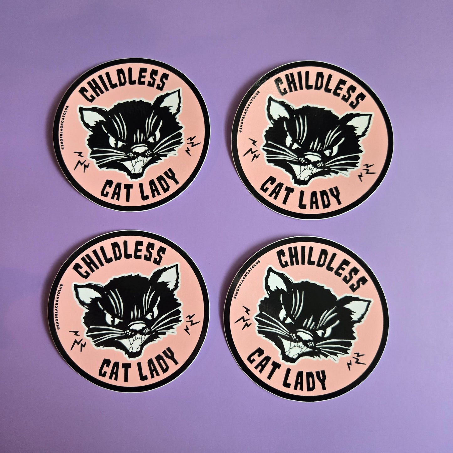 4 round pink stickers with the text 'Childless Cat Lady' on it, depicted in a stylized font with black cat illustration,