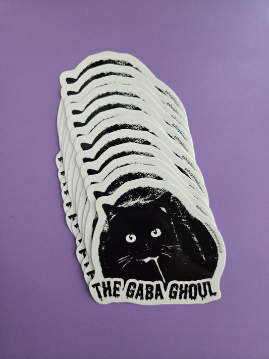 Stack of black and white stickers with 'The Gaba Ghoul' design on a purple background