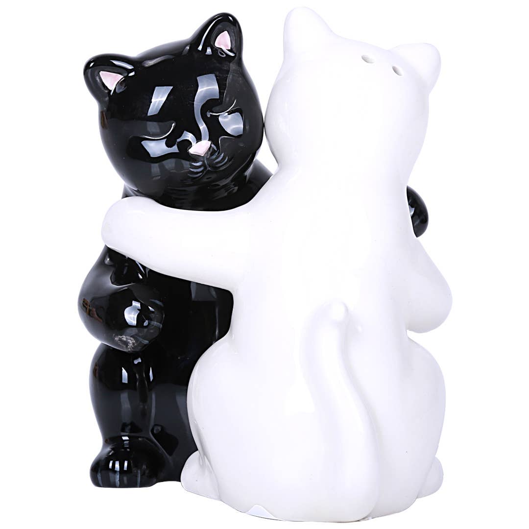 Black and white ceramic hugging cat salt and pepper shakers on a white background