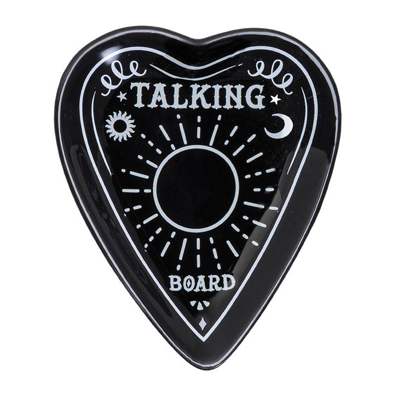 A black ceramic trinket dish in the shape of a planchette with 'TALKING BOARD' text and sun and moon motifs.