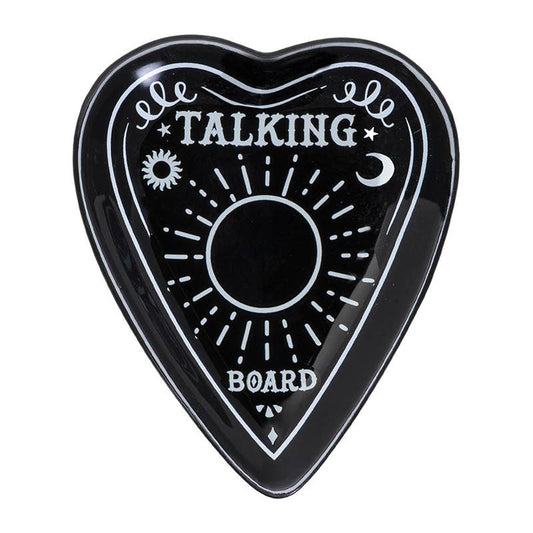 A black ceramic trinket dish in the shape of a planchette with 'TALKING BOARD' text and sun and moon motifs.