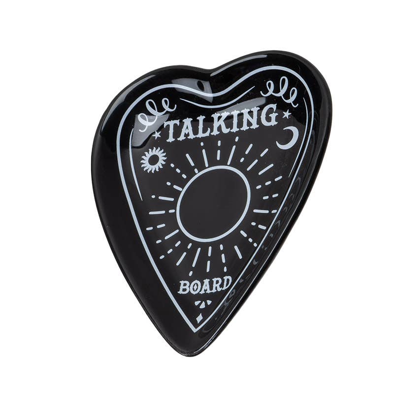 A black ceramic trinket dish in the shape of a planchette with 'TALKING BOARD' text and sun and moon motifs. Side view.