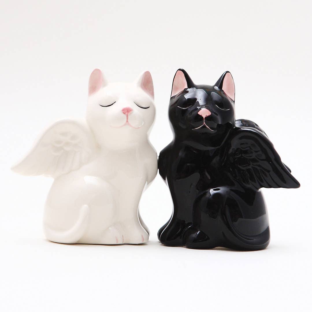 White and black cat salt and pepper shakers with angel wings on a white background