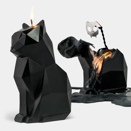 A black cat-shaped candle with a metallic skeleton design inside, partially melted to reveal the skeleton, placed on a white surface.