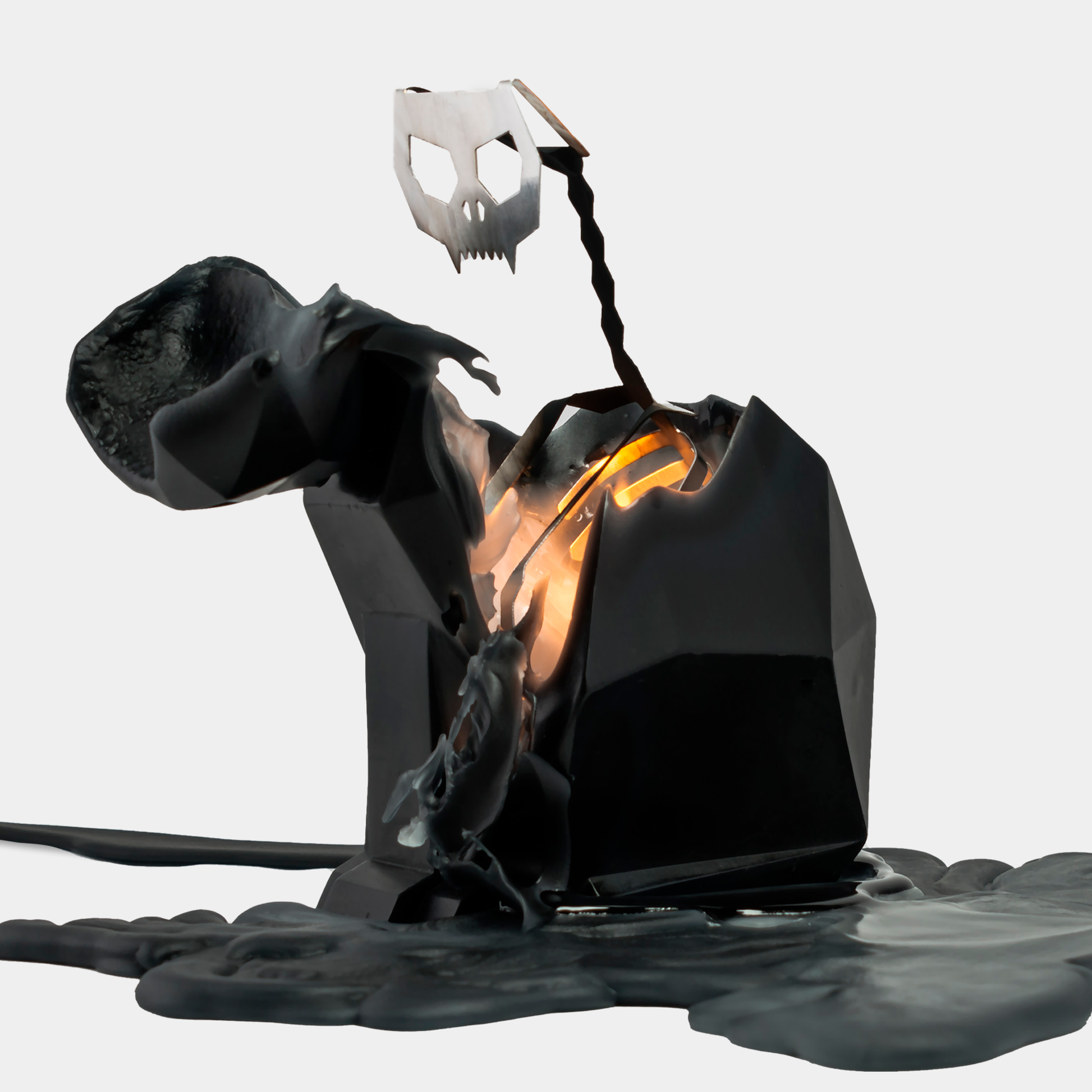 A black cat-shaped candle with a metallic skeleton design inside, partially melted to reveal the skeleton