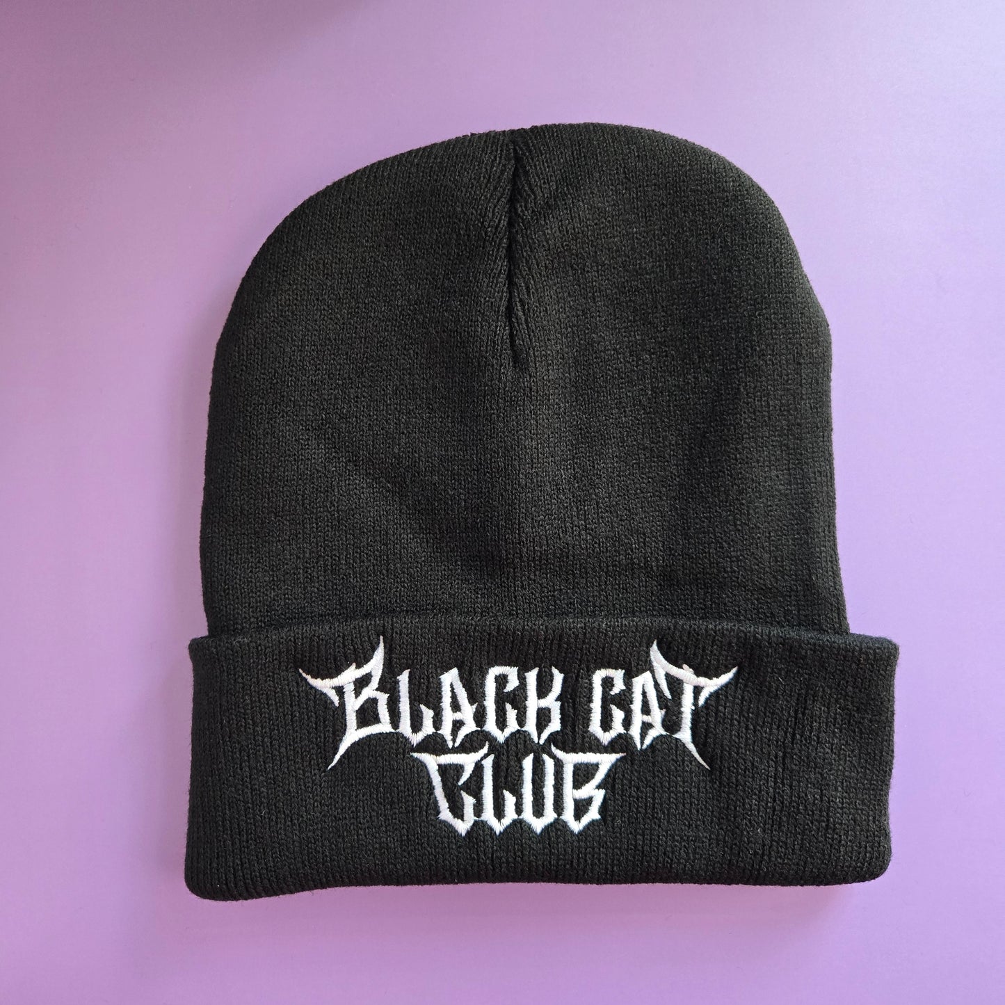 Black beanie with 'Black Cat Club' logo embroidered in white on the cuff.