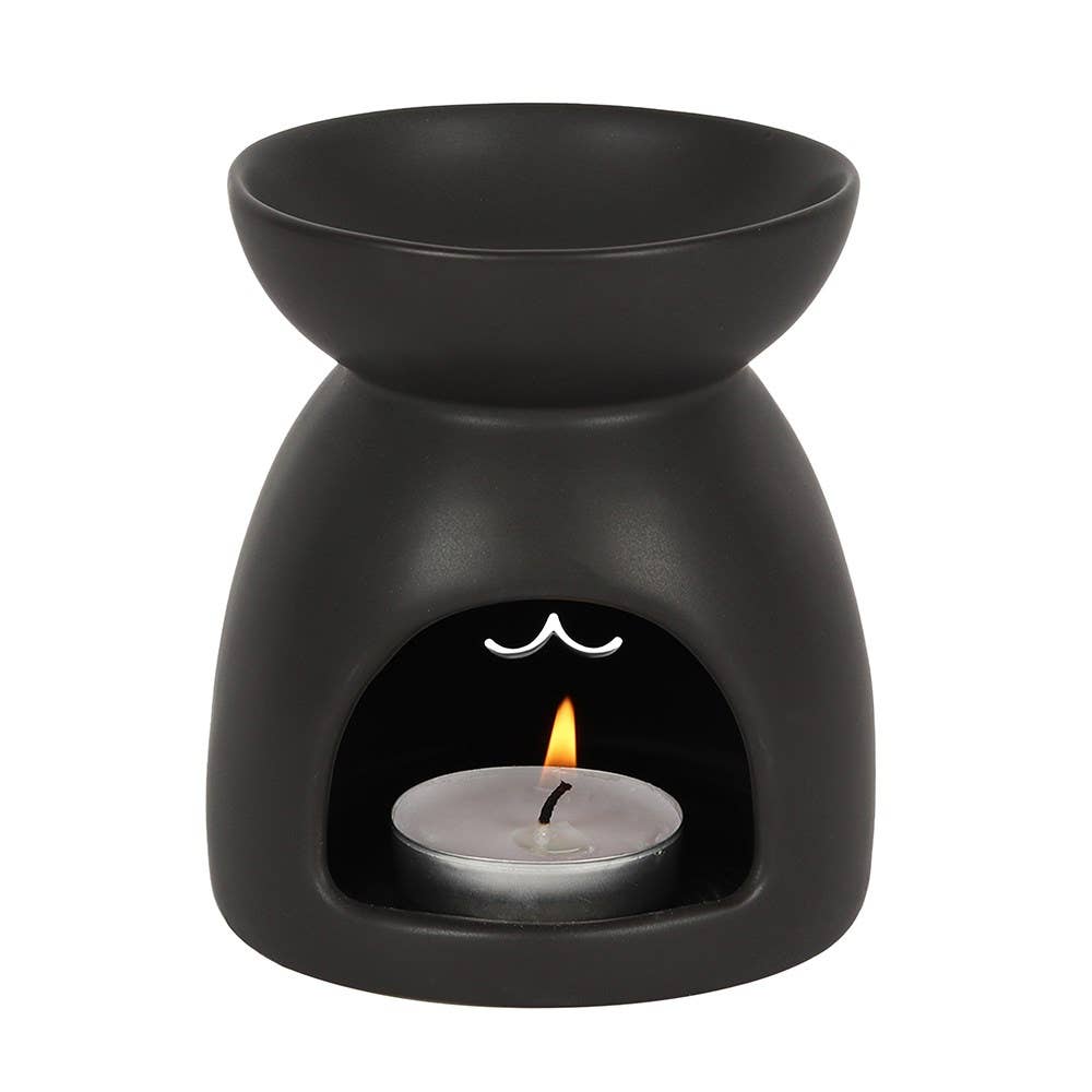 Back view of oil burner showing a lit tea light candle. 