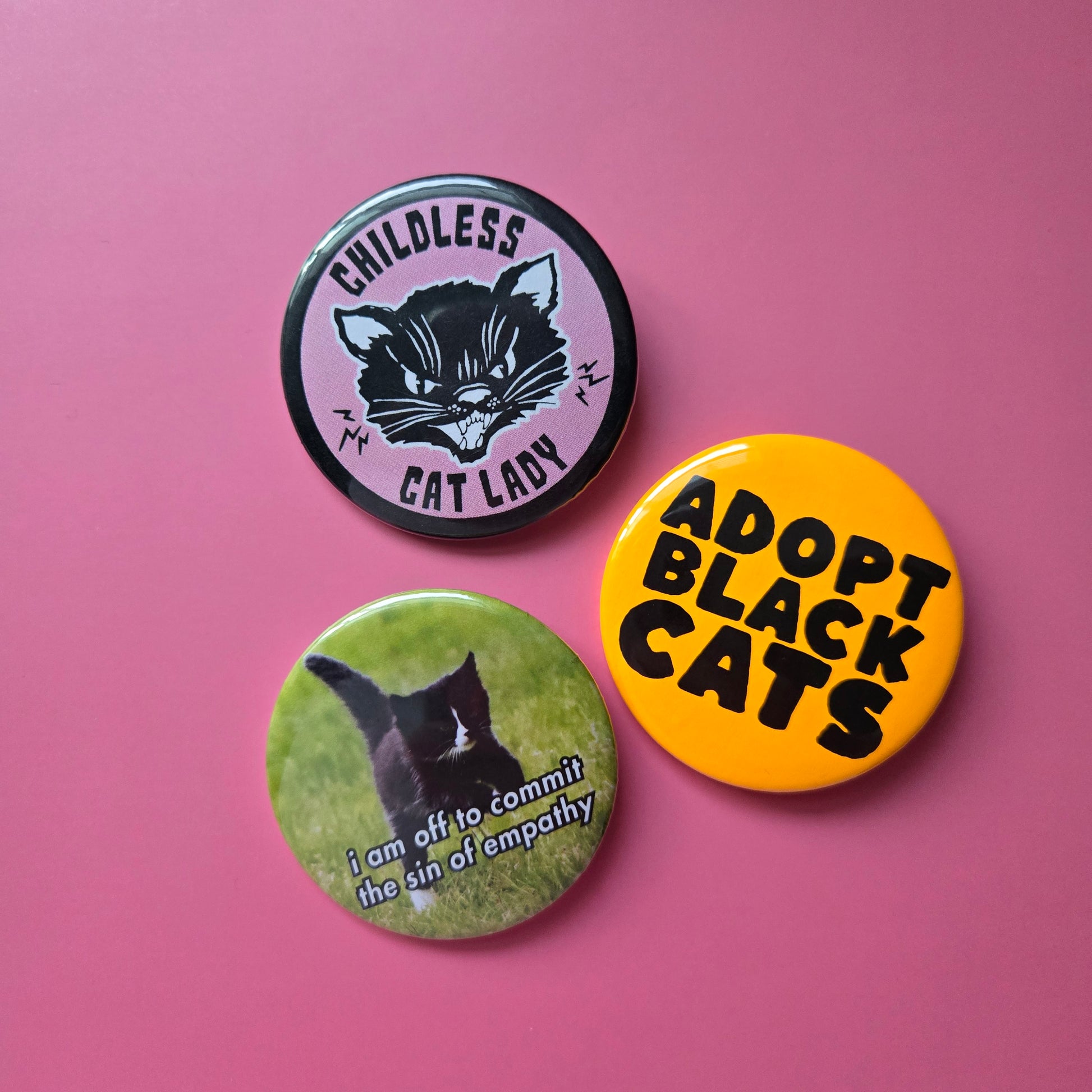 display of 3 round buttons on a pink background