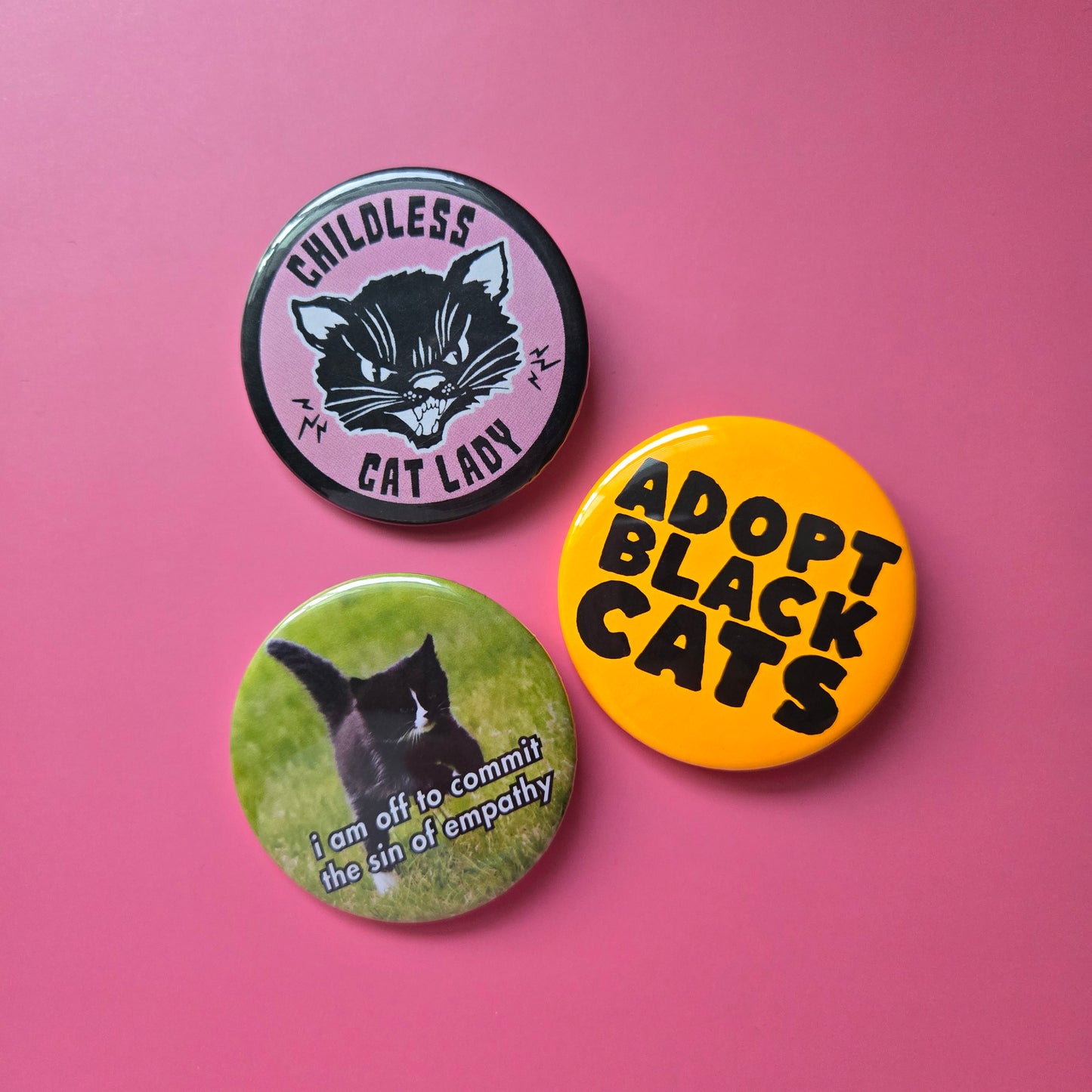 display of 3 round buttons on a pink background