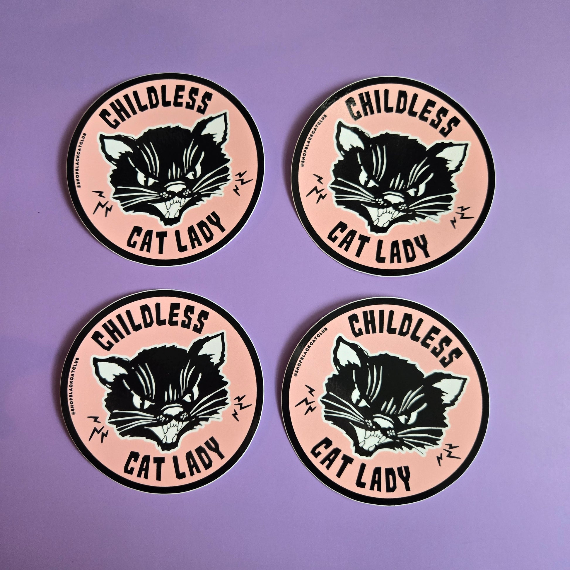 4 round pink stickers with the text 'Childless Cat Lady' on it, depicted in a stylized font with black cat illustration,