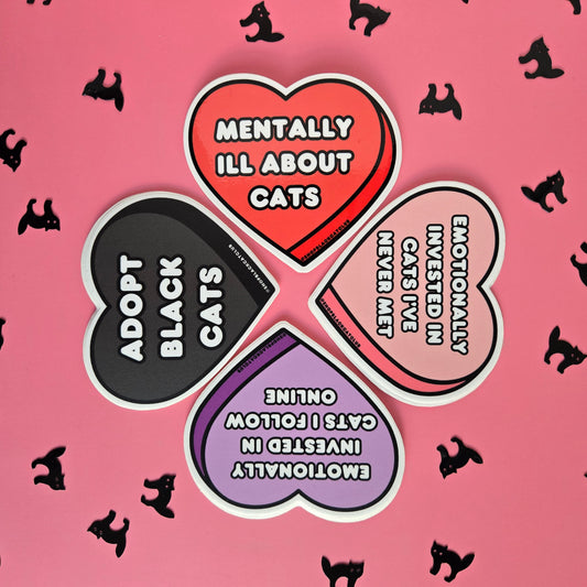 Display of 4 heart shaped stickers on a pink background with Halloween black cat confetti