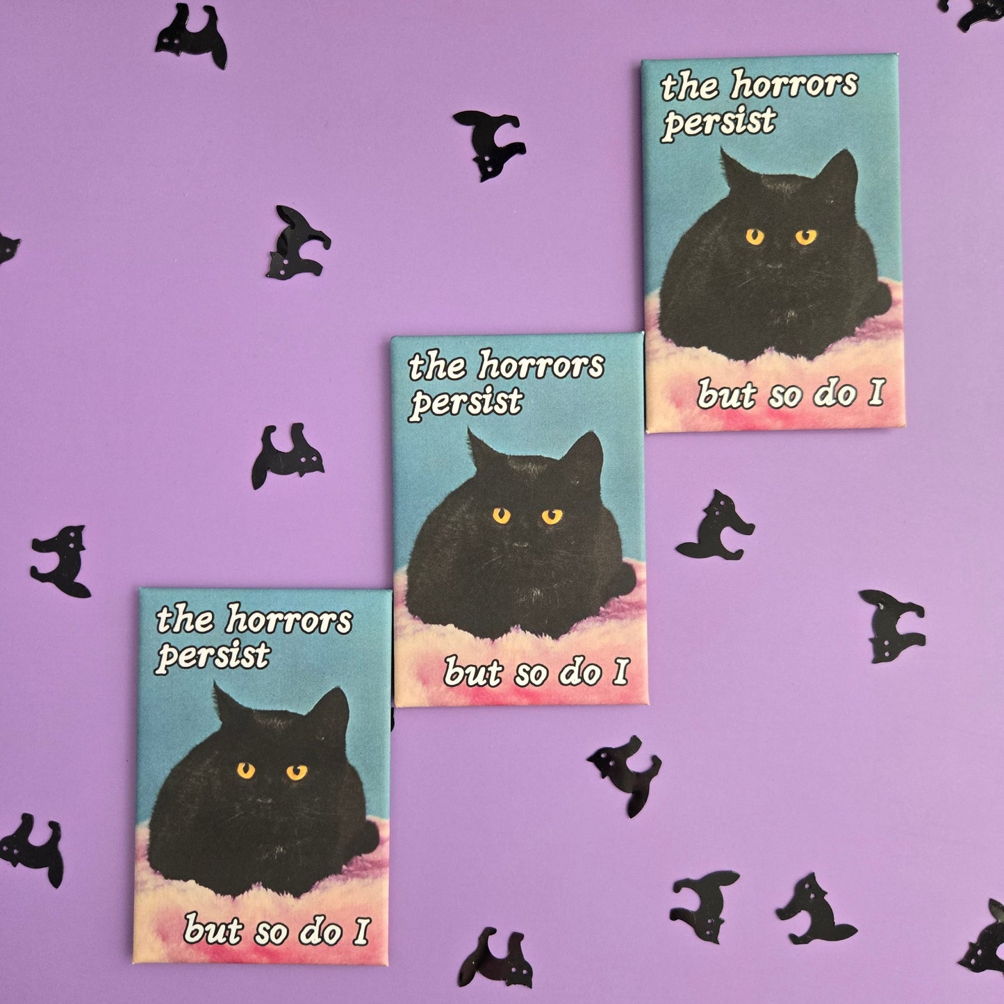 3 rectangular magnet with vintage black cat photo and text reading The Horrors Persist But so Do I displayed on a purple background with black cat confetti.